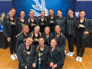 NWU Gold Rush dance team at the UDA Spirit of the Midwest Challenge with their first-place trophy. 